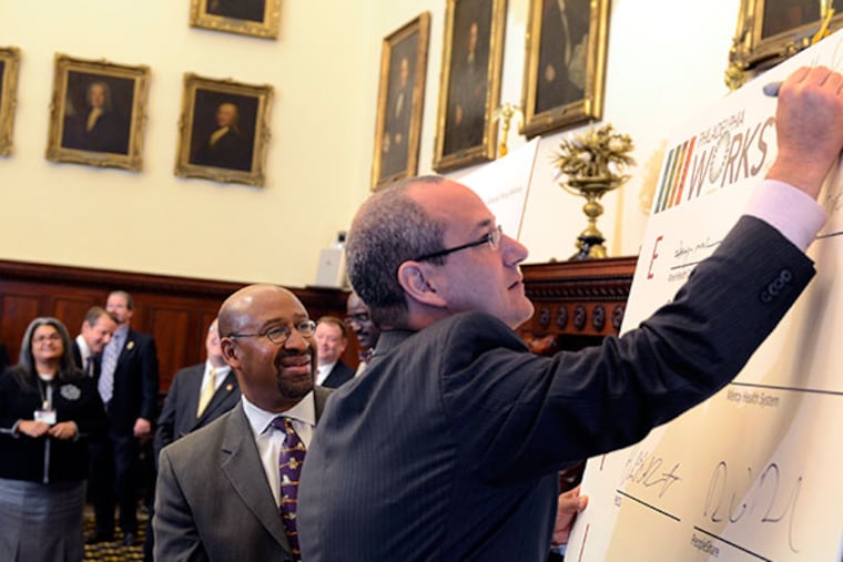 Mayor Michael Nutter (left) looks on as Michael Nenner (front), hotel manager at the Four Seasons Hotel in Philadelphia, adds his signature to the first-ever “Philadelphia Jobs Compact” during a press conference at City Hall October 22, 2013. (TOM GRALISH / Staff Photographer)