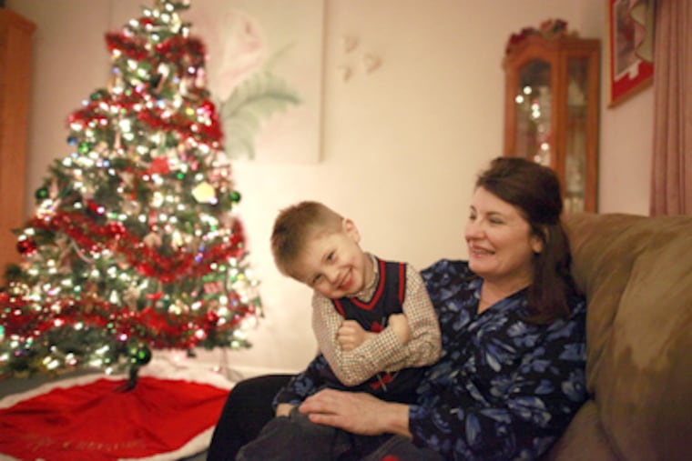 Donna Oxford, with grandson Michael, 3, found a new, lower-paying job but faces foreclosure on her house. (David Swanson / Staff Photographer)