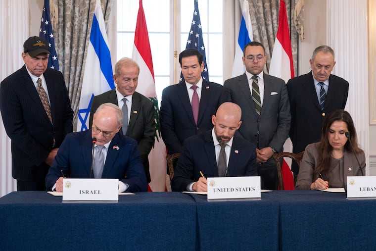 Secretary of State Marco Rubio and others watch, seated from left, Israel's Ambassador to the U.S. Yechiel Leiter, counselor Dan Holler, and Lebanon's Ambassador to the U.S. Nada Hamadeh, sign a framework agreement, described as a first step toward peace following months of conflict between Israel and the Lebanese militant group Hezbollah, at the State Department, Friday, June 26, 2026, in Washington.