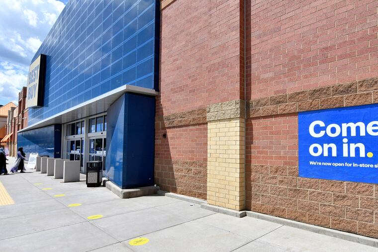 Shoppers, left, headed to the entrance as a sign on the outside wall invited customers to shop inside a Best Buy store Wednesday in Richfield, Minn. as restrictions because of the coronavirus have eased in Minnesota.