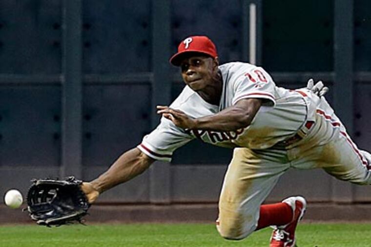 Juan Pierre can't reach a ball hit by Tyler Greene during the fourth inning. (David J. Phillip/AP)