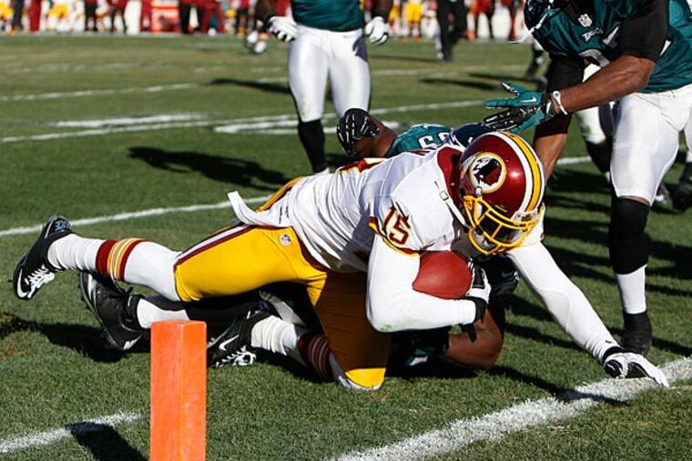 The Redskins' Joshua Morgan, left, dives for the endzone during the 2nd quarter.The play was ruled a touchdown. (David Maialetti/Staff Photographer)
