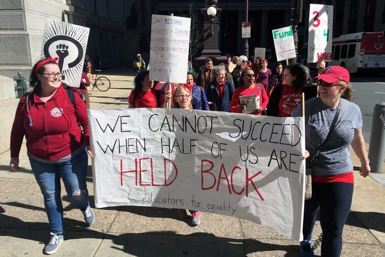 Philadelphia teachers from Bayard Taylor Elementary and Science Leadership Academy march around City Hall as part of Wednesday's Day Without a Woman protest,