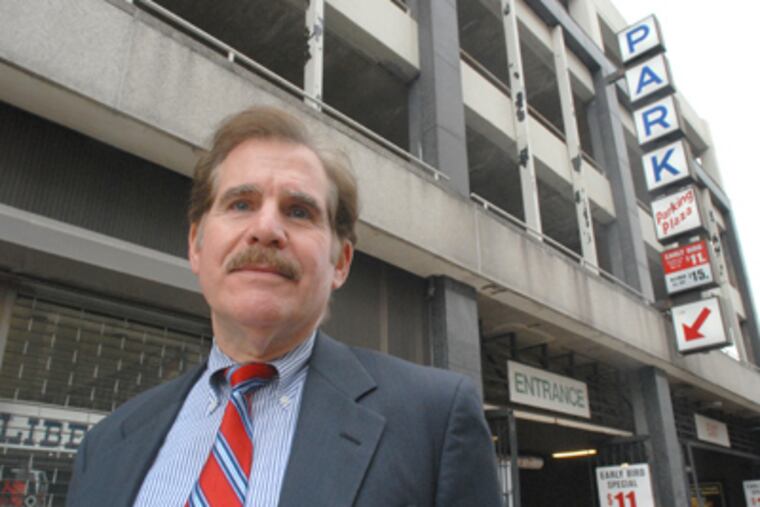 In Philadelphia, Alan Horowitz stands in front of the parking garage at 8th and Arch streets where his car was broken into. (April Saul / Staff Photographer)