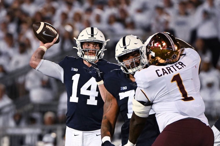 Penn State quarterback Sean Clifford (14) throws a pass to wide receiver Parker Washington in the Nittany Lions' commanding 45-17 win over the Golden Gophers on homecoming.
