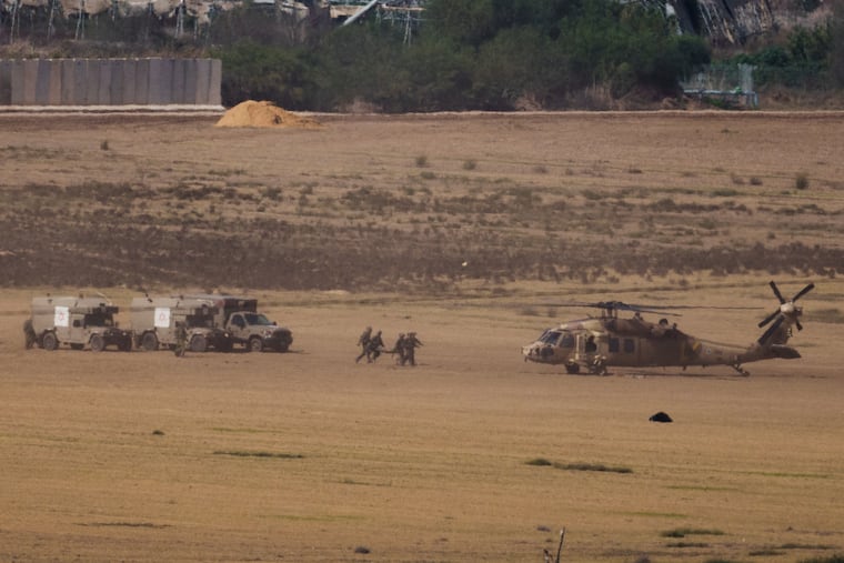 Israeli soldiers carry a stretcher toward a helicopter near the border with Gaza Strip, as seen from southern Israel on Tuesday.