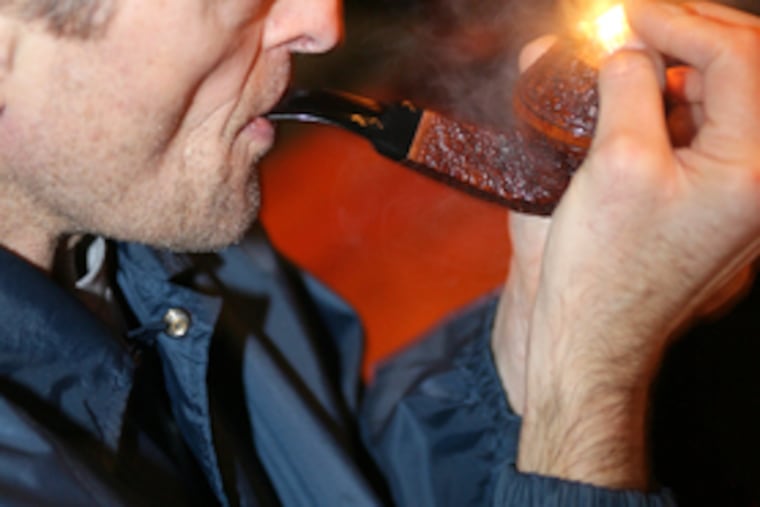 Louis Zisholz lights up during the Christopher Morley Pipe Club meeting at the Pen & Pencil Club last month.