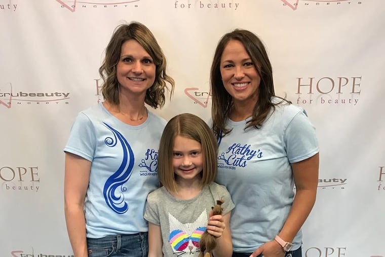 Kathy Romano (right) with volunteers Kara Antenucci (left) and Addison Antenucci.