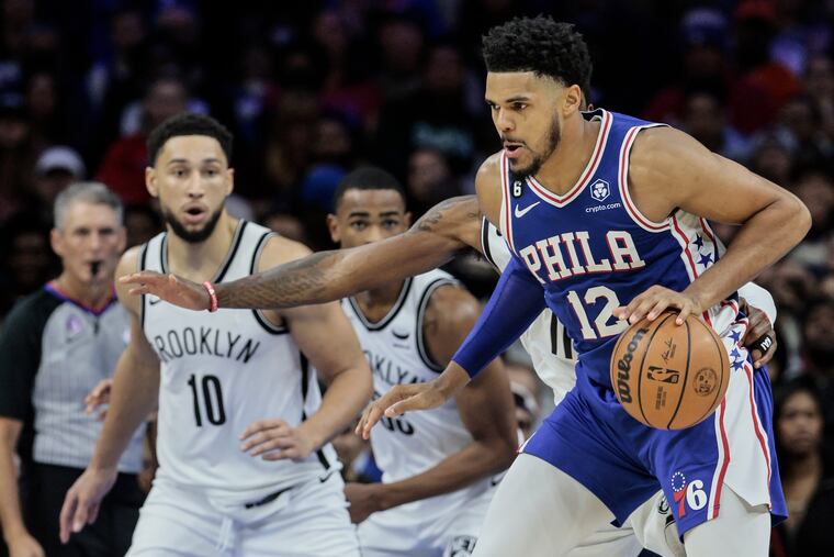 Sixers Tobias Harris drives on Nets Kyrie Irving and Ben Simmons during the 3rd quarter at the Wells Fargo Center in Philadelphia, Tuesday, November 22, 2022.