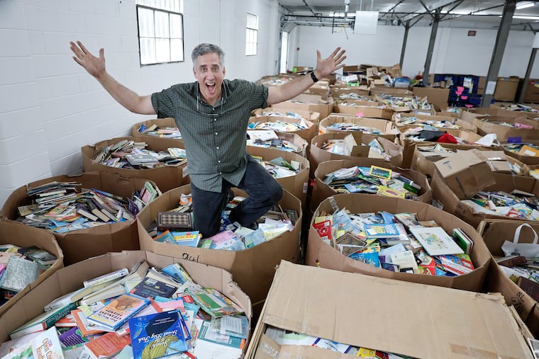 BookSmiles founder Larry Abrams among gaylords of books that need to be sorted in BookSmiles' new Cherry Hill warehouse on Friday, Aug. 28, 2026. Each gaylord holds about 1,500 books and weighs about 1,100 pounds.