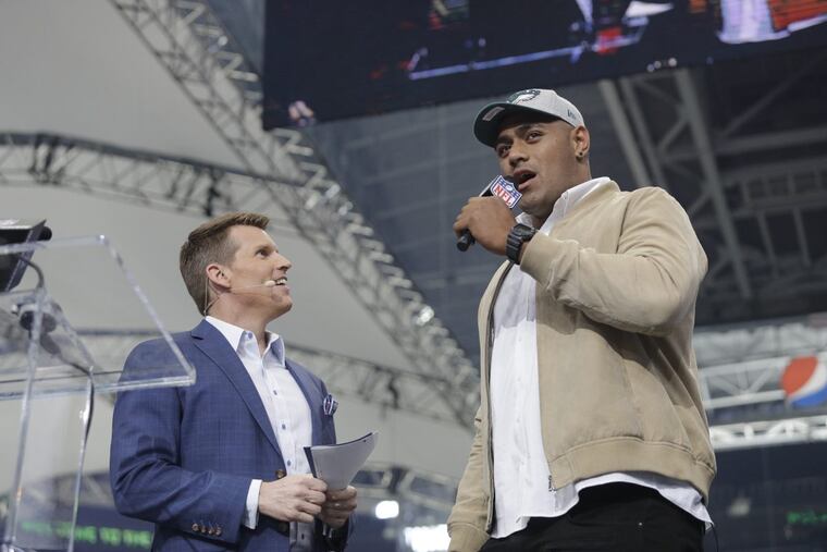 Australian rugby player Jordan Mailata, right, appears onstage after being selected by the Eagles in the seventh round of the NFL draft on Saturday.