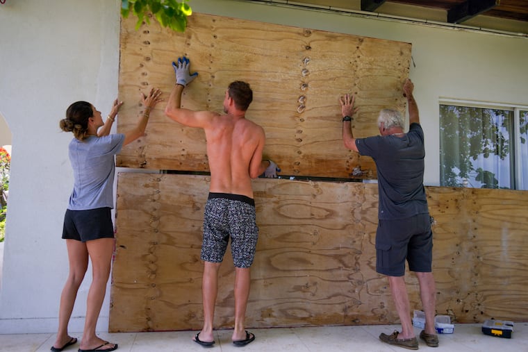Residents cover the windows of their home in preparation for the arrival of Hurricane Beryl in Bridgetown, Barbados, on Sunday.
