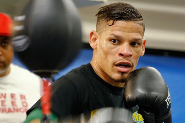 Boxer Orlando Cruz, right, works out at Mendez Boxing Gym, in New York. Cruz won the big fight of his life outside the ring when he came out as the first openly gay boxer. Now he fights for a championship Saturday night, Oct. 12, in the biggest fight of his boxing career. (AP Photo/Nat Castaneda, File)