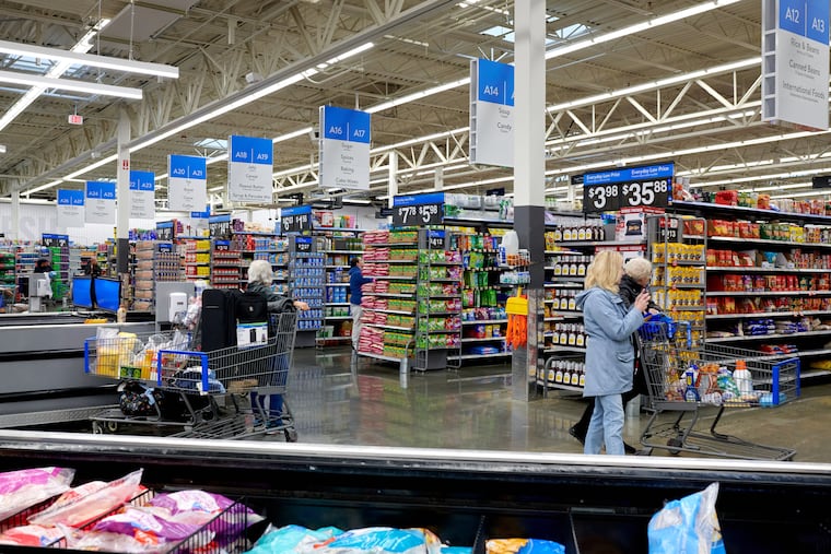 Customers shop for groceries at a Walmart store in Secaucus, New Jersey, US, on Tuesday, March 5, 2024.