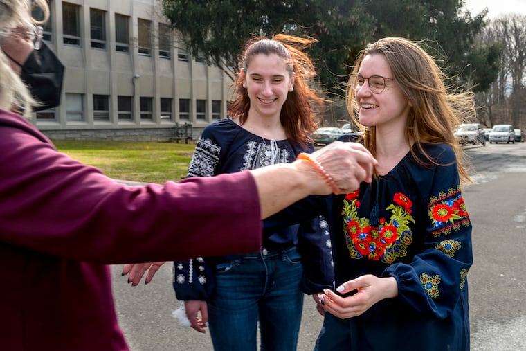 Vera Penkalskyj and Marta Penkalskyj (right), sisters raised in Ukrainian culture and both grads of Manor College, greet a friend they haven’t seen for years, Chrystyna Prokopovych, curator of the college’s Ukrainian Heritage Studies Center, as they visit the school Wednesday. They have family in Ukraine, and Marta has been living there, returning home just recently.