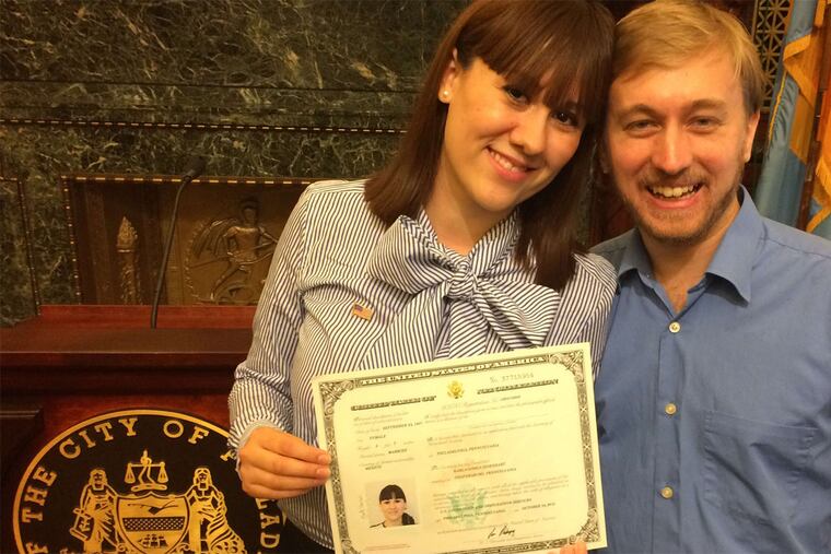 Karla Marquez Eisenhart shows her citizenship certificate alongside her husband, Michael Eisenhart.