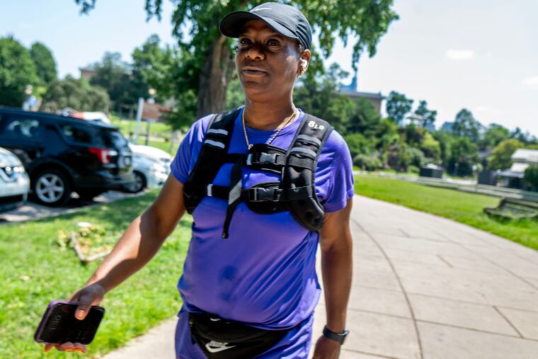 Marquena Carter of North Philadelphia walks along Waterworks Drive while wearing an 8-pound weighted vest Sunday, Aug. 3, 2025. The vests are becoming more common among everyday exercisers after years of popularity in military and law-enforcement circles.