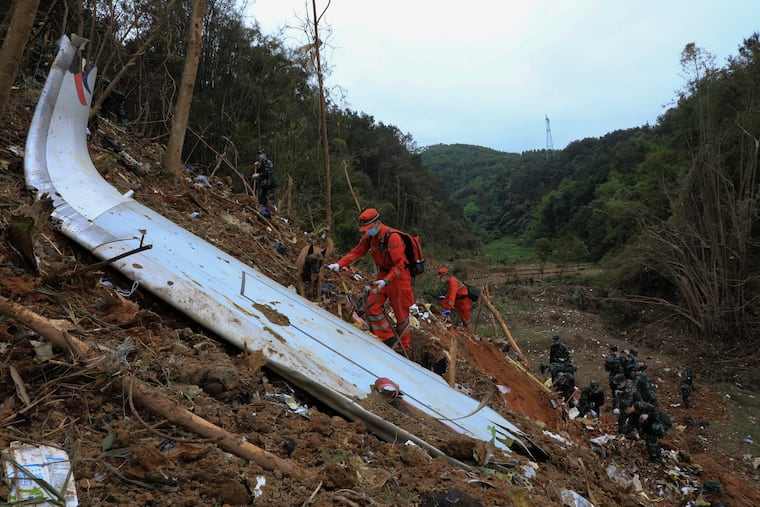 Emergency workers searching for the black box at the crash site of the China Eastern flight in Teng County, China in 2022.