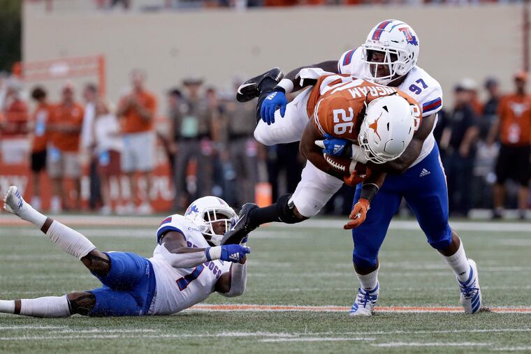 Eagles draft pick Milton Williams (right) tackles Texas running back Keaontay Ingram.