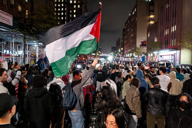 Pro-Palestinian protesters gather near an area where people were being taken into custody near the Columbia University campus in New York on Tuesday after a campus encampment and a campus building, taken over by protesters earlier in the day, were cleared by New York City police.