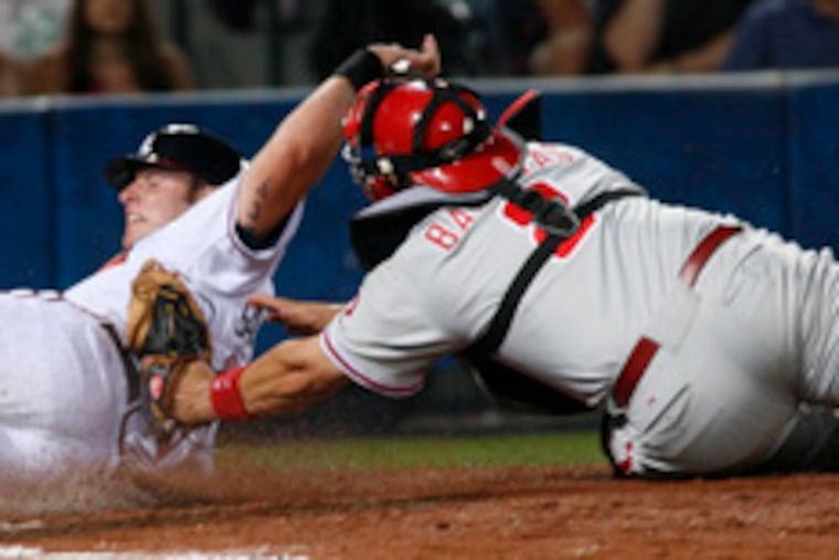 Phillies catcher Rod Barajas tags out Jarrod Saltalamacchia in the sixth. He was trying to score from third on a fly ball by Kelly Johnson.