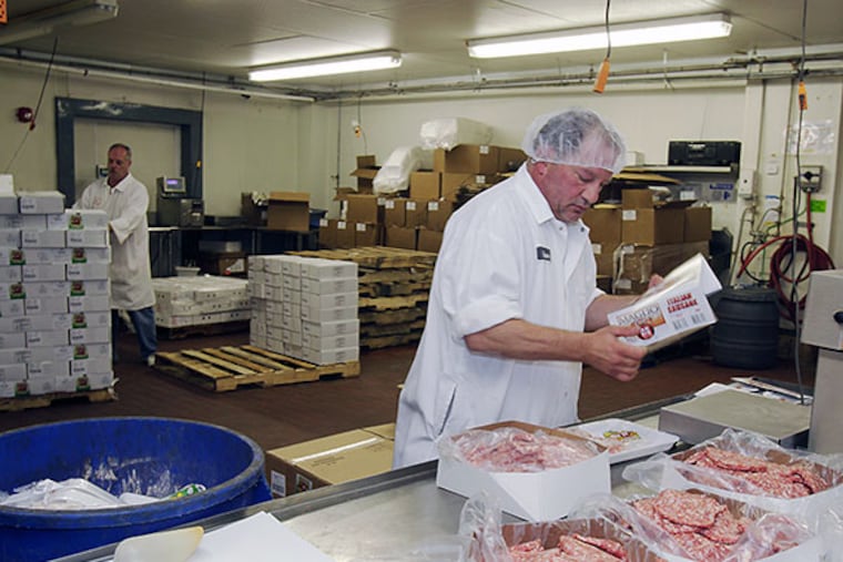 Steve Dalessio packs meat in a soon-to-close packing room on July 7, 2014.( AKIRA SUWA / Staff Photographer )