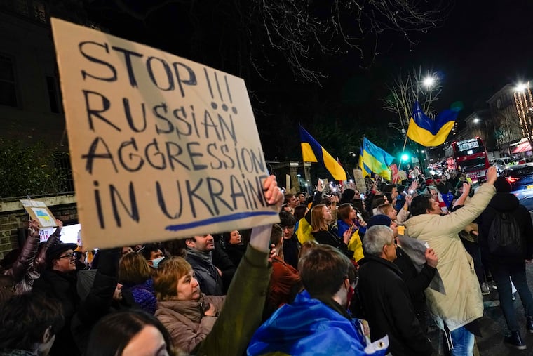 Demonstrators hold placards and flags as they attend a protest outside the Russian Embassy, in London, Wednesday, Feb. 23, 2022. Prime Minister Boris Johnson said Thursday he would push forward legislation on a long-stymied register of overseas property ownership as the U.K. sanctioned more than 100 Russian individuals and entities, part of a coordinated push by Western countries against Russian companies and oligarchs in the wake of that nation's invasion of Ukraine.