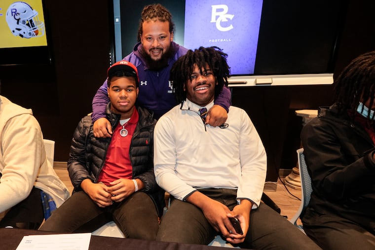 Roman Catholic held a national signing day event at the school, with nine students signing. Temple signee Jordan Montgomery (left) and Penn State signee Jameial Lyons (right) with head coach Rick Prete.