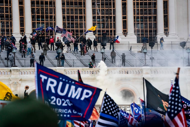 Supporters of US President Donald Trump clash with the Capitol police during a riot at the U.S. Capitol on Jan. 6, 2021, in Washington, DC.