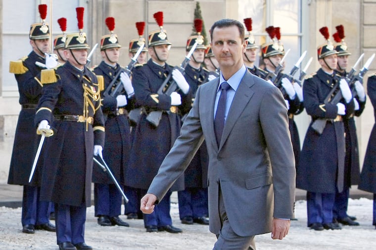 FILE - In this Dec. 9, 2010 file photo, Syria President Bashar al-Assad arrives at the Elysee Palace in Paris for his meeting with French President Nicolas Sarkozy.