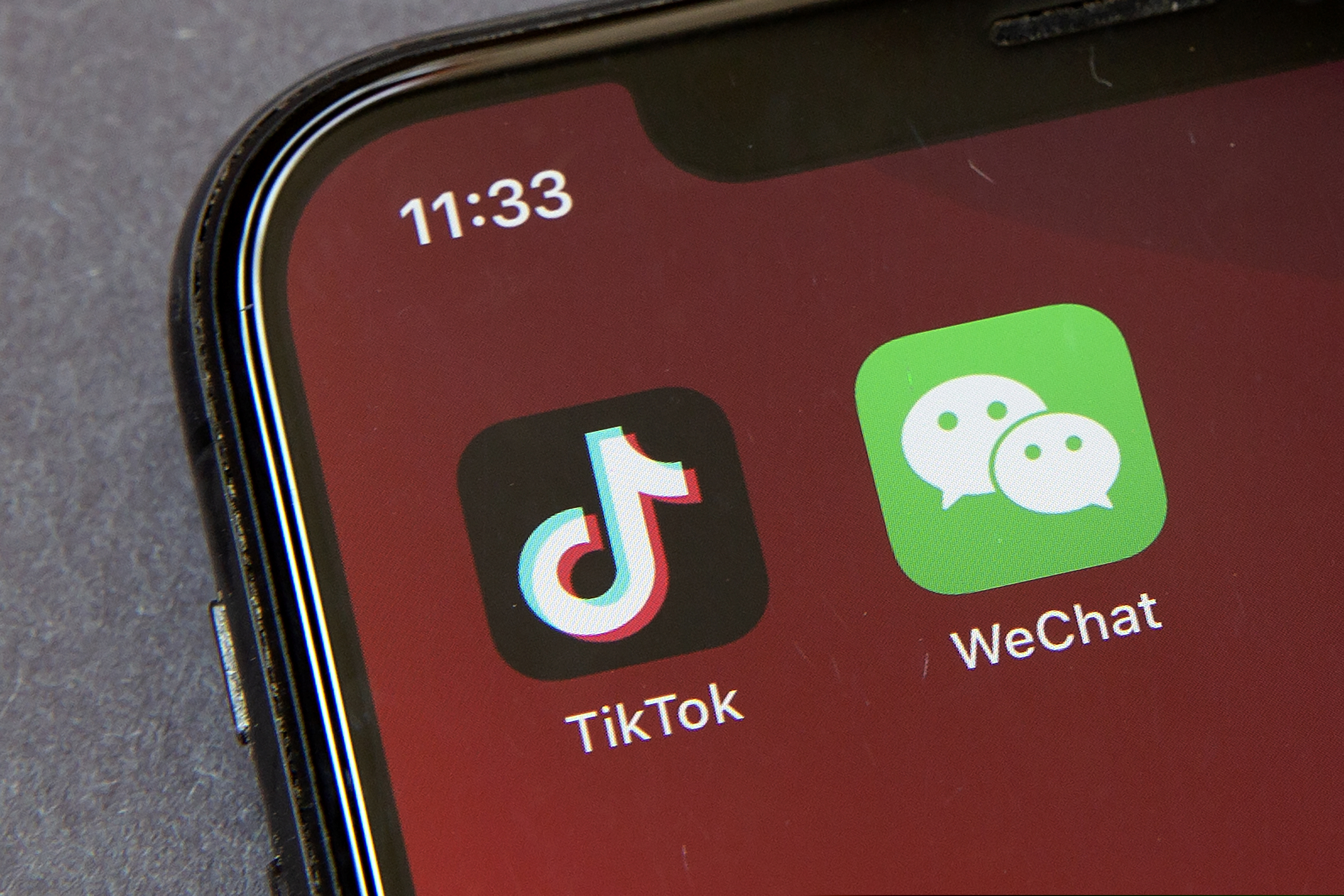 Icons for the smartphone apps TikTok and WeChat are seen on a smartphone screen in Beijing. The U.S. government is cracking down on the Chinese apps TikTok and WeChat, starting by barring them from app stores on Sunday, Sept. 20, 2020.