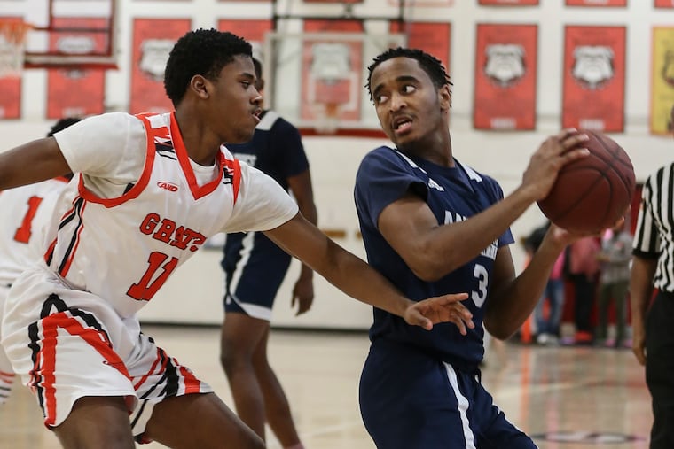 Math, Civics and Sciences' Marcus Middleton (right) scored the winning basket at the overtime buzzer in a 70-69 victory over Simon Gratz.