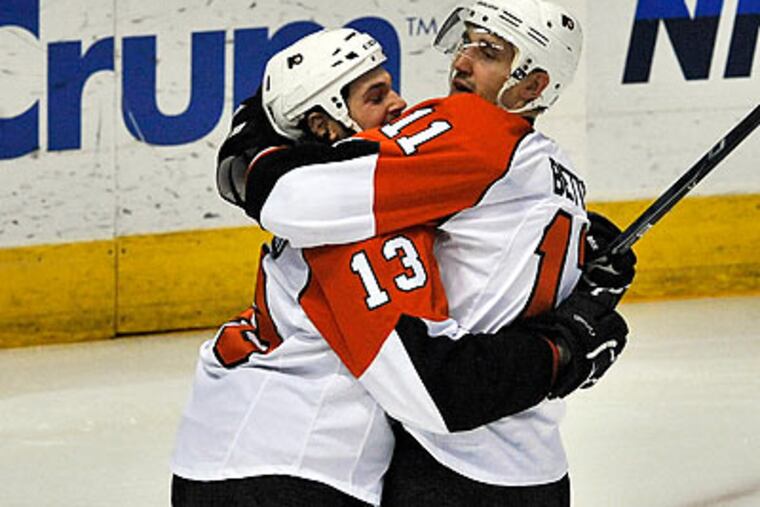 Dan Carcillo celebrated with Blair Betts after Betts scored a goal during the first period. (Steve Nesius/AP)