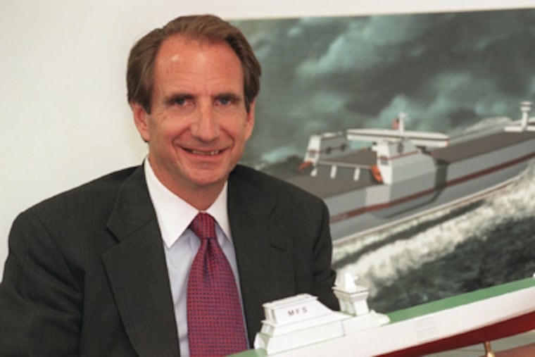 FastShip chief Roland K. Bullard 2d with a model of one of his company's proposed cargo vessels.