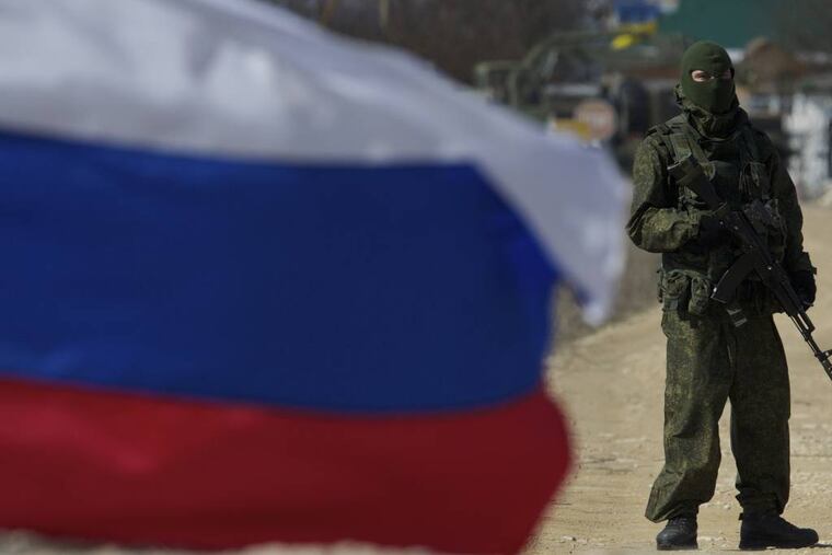 Pro-Russian soldiers block the Ukrainian naval base in the village of Novoozerne, some 91 km west of Crimean capital Simferopol, Ukraine, on Monday, March 3, 2014. Ukraine says Russian forces controlling the strategic region of Crimea are demanding that the crew of two Ukrainian warships in Sevastopol's harbor must surrender. (AP Photo/Ivan Sekretarev)