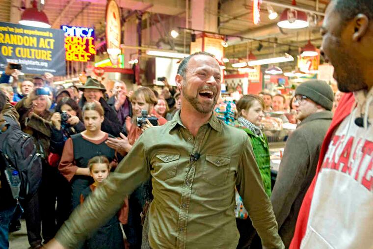 At the end of the performance, baritones Troy Cook (left) and Norman Garrett share a laugh as some shoppers continue to snap pictures inside the marketplace.