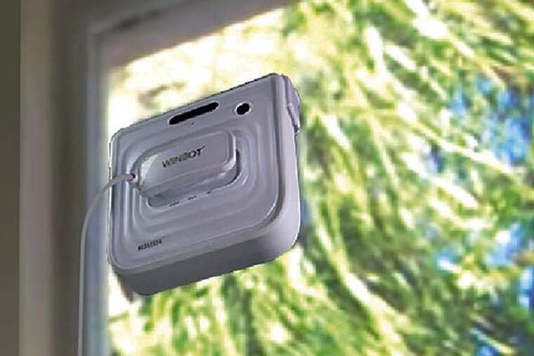 The Ecovacs robotic window cleaner at work. It seals itself to the glass, applies liquid cleaner, then wipes the glass clean. But how clean?