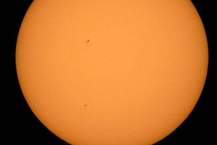 The planet Mercury is seen in silhouette, lower third of image, as it transits across the face of the sun Monday, May 9, 2016, as viewed from Boyertown, Pa.