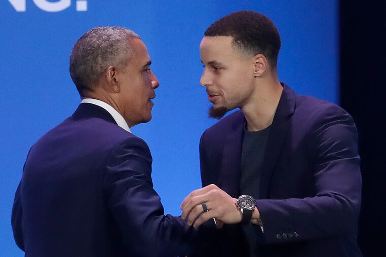 Former President Barack Obama, left, hugs Golden State Warriors basketball player Stephen Curry after speaking at the My Brother's Keeper Alliance Summit in Oakland, Calif., Tuesday, Feb. 19, 2019.