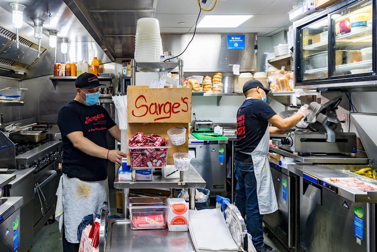 Staff from Sarge's Delicatessen work in the kitchen at Zuul in the Manhattan borough of New York.
