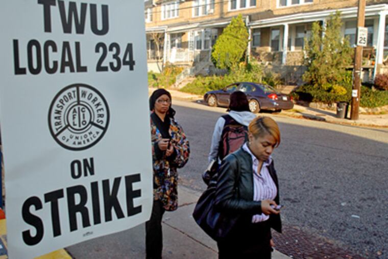 Commuters pass picket sign outside the closed Broad Street subway station, after Transport Workers Union Local 234 workers went on strike in the early hours of Tuesday, November 3. ( Tom Gralish / Staff Photographer )