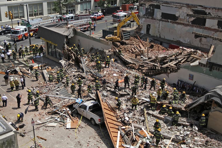 May 5, 2013: Philadelphia firefighters and police search for survivors following a wall collapse at a demolition site on Market Street that killed six people and injured many more inside a Salvation Army thrift store. MICHAEL BRYANT / Staff Photographer
