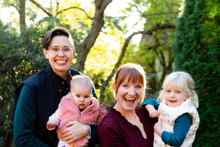 Jackie, on left, holding Quinn and Kimber, on right, holding Abigail.