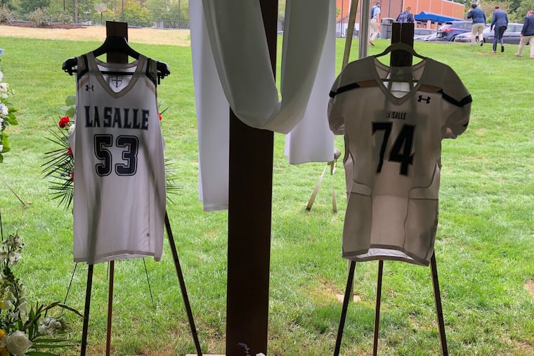 Isaiah Turner's basketball and football jerseys for La Salle High hung at his funeral Sept. 11. The 17-year-old, who collapsed after practice on Sept. 4, died of a sickle cell crisis, according to a spokesperson for the Philadelphia Medical Examiner's office.