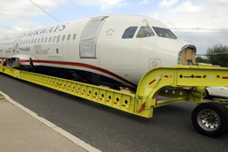 The plane that crashed into the Hudson makes its way through Gloucester. (Ron Tarver / Staff Photographer)