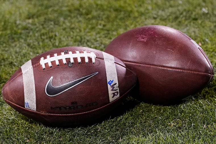 FILE - Footballs rest on the field in the second half of an NCAA college football game Nov. 28, 2020, in Boulder, Colo. (AP Photo/David Zalubowski, File)