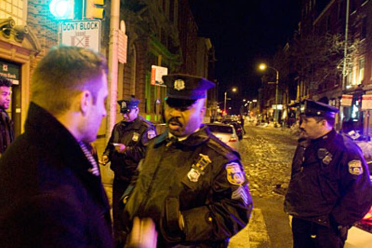 Philadelphia police Sgt. Dennis Vest talks with people as they exit nightclubs along 2nd Street in Old City. (Ron Taver / Staff Photographer)