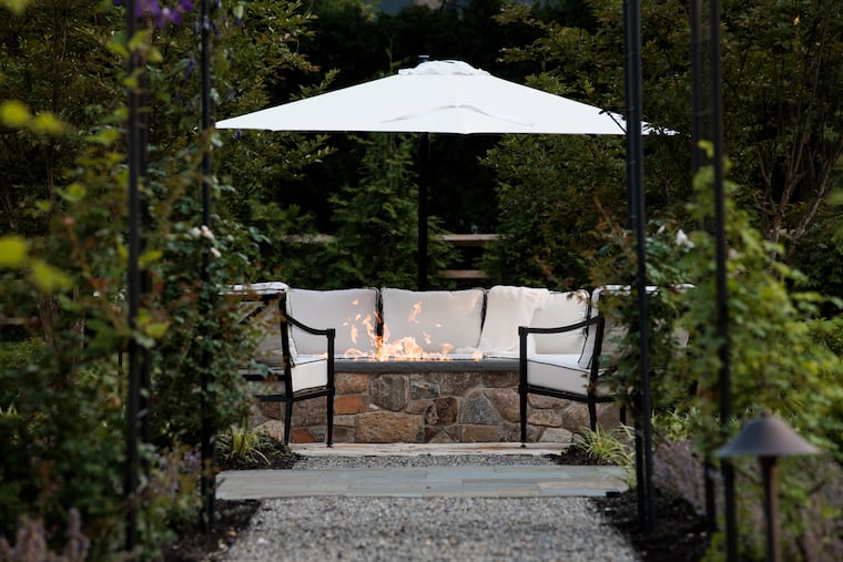 A path leads through the garden to the fire pit and patio in the backyard at the home of Ali and John Jennings on Thursday, June 12, 2025 in Moorestown, NJ.
