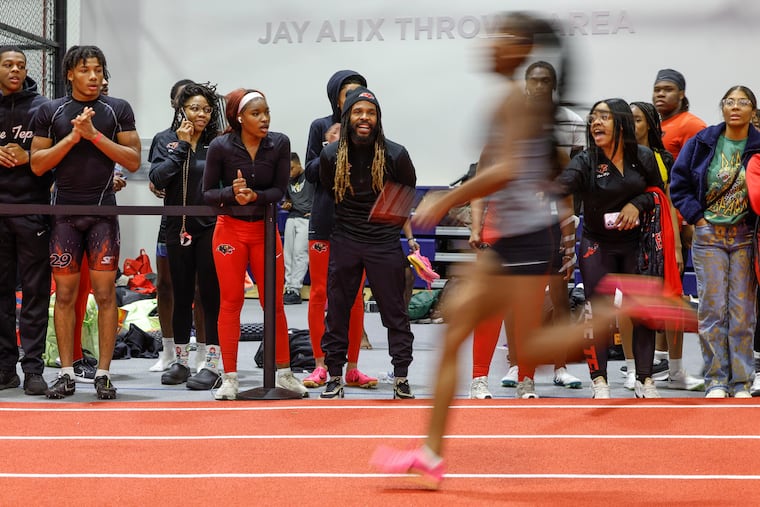 Anthony Bishop, Imhotep Charter's track coach, watches his team during the first Public League indoor track and field meet Thursday at Penn's Ott Center.