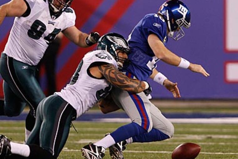 Jason Babin caused a crucial fumble against Giants quarterback Eli Manning late in the fourth quarter. (David Maialetti/Staff Photographer)